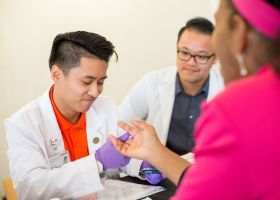 PharmD students helps patient at clinic