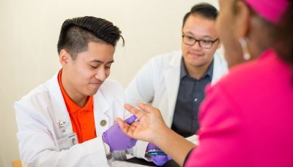 PharmD students helps patient at clinic