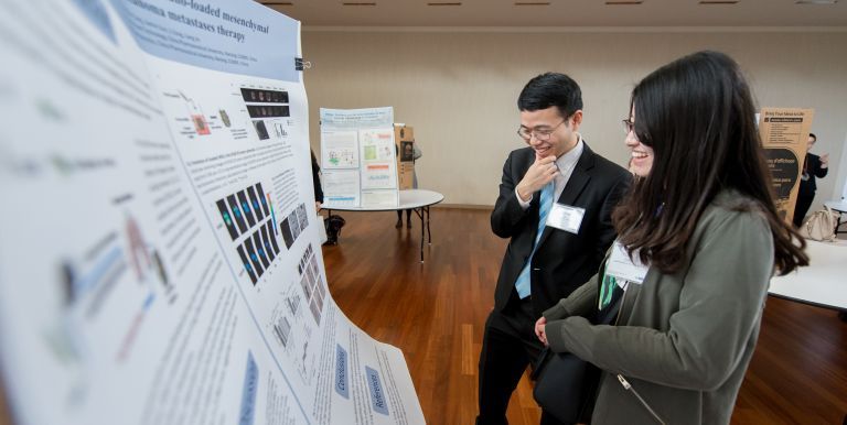 PCSP student presenting reserach poster