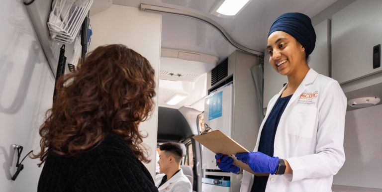  doctor of pharmacy student with patient in mobile clinic van