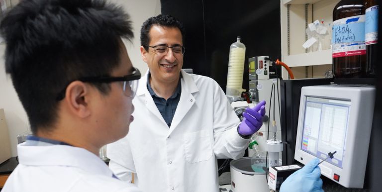 faculty member Mamoun Alhamadsheh in research lab with graduate students
