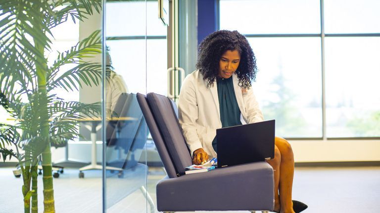 PharmD student with laptop outside quiet study area