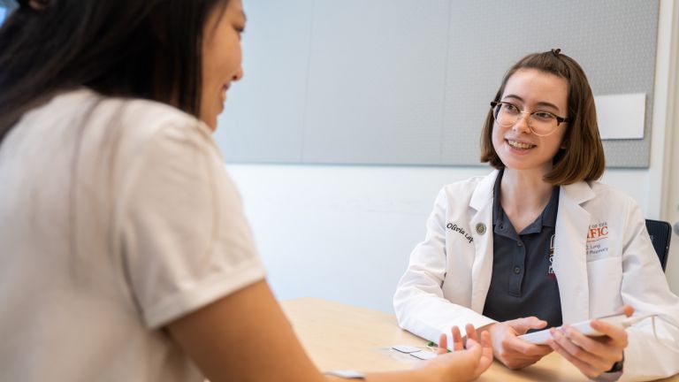 doctor of pharmacy student with patient