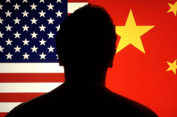 Silhouette against USA and China flags