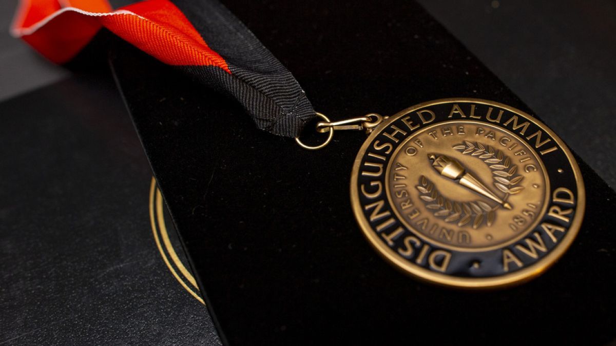 medal reading Distinguished Alumni Award