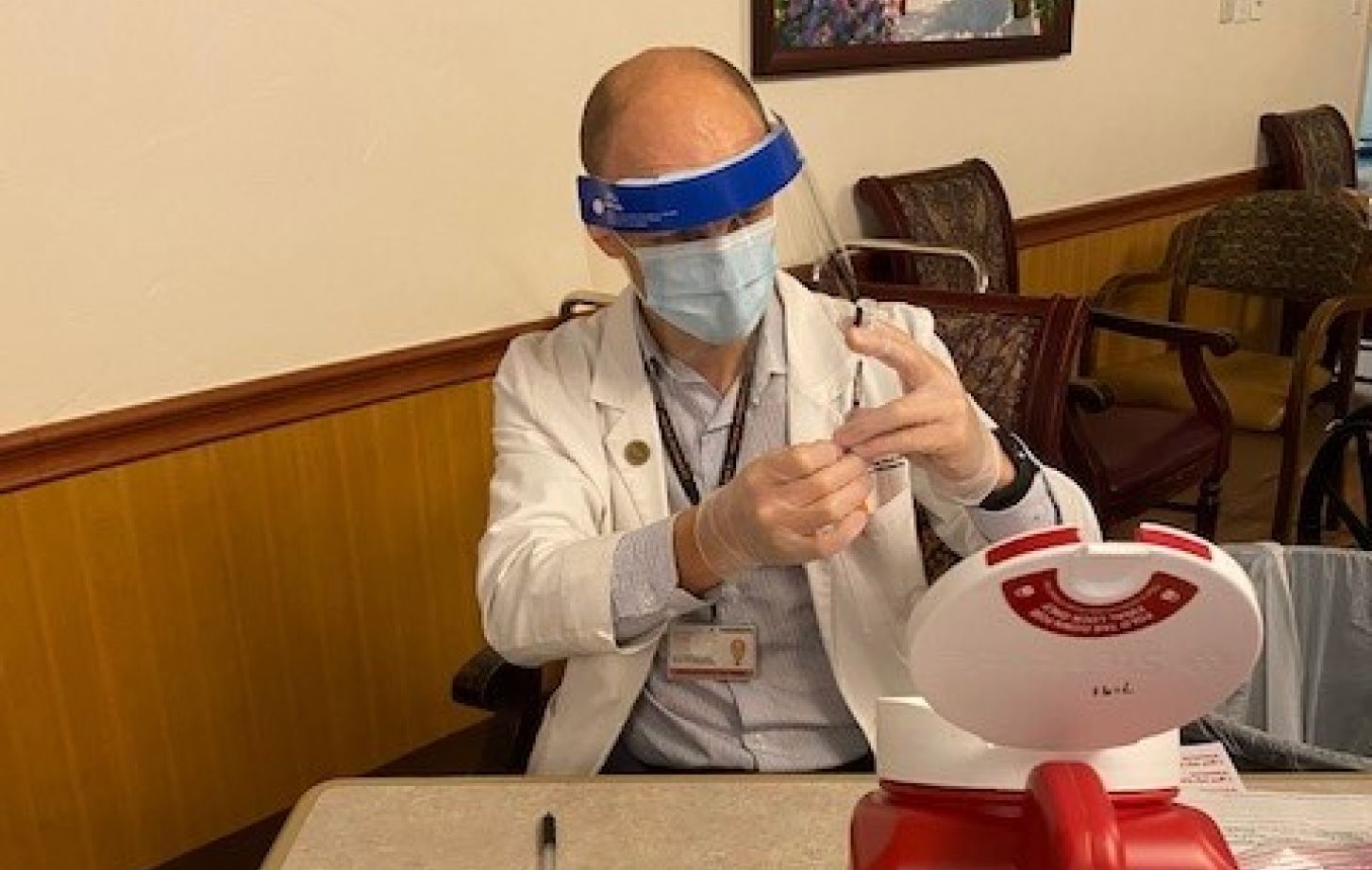 Student mixing a vaccine
