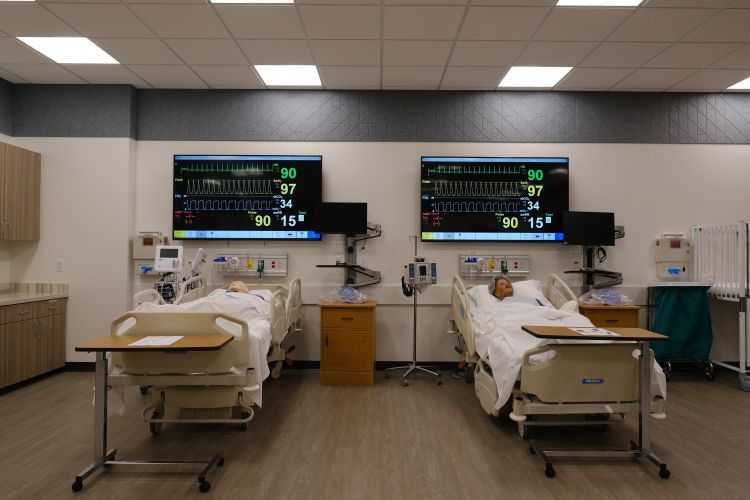 Clinical lab with manikins lying in hospital bed