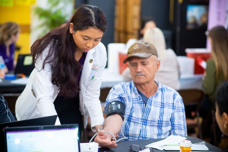 student helps patient