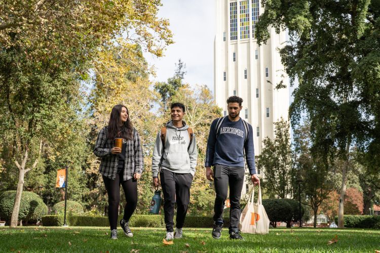 students walk across campus 