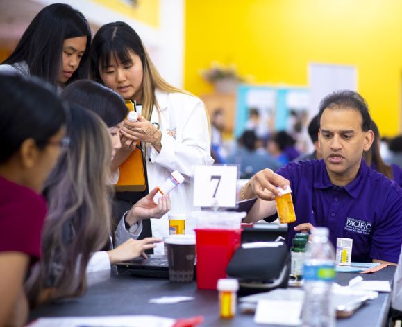 Raj Patel with PharmD students at Medicare Part D Outreach Clinic event