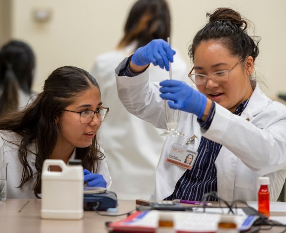 Two pharmacy students in the compounding lab