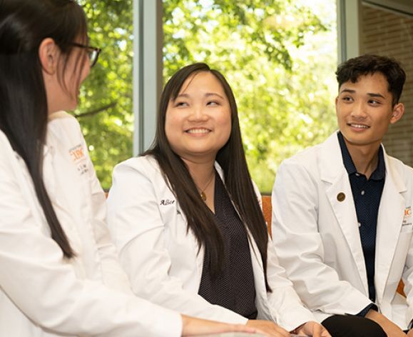 Students smiling and having a conversation.