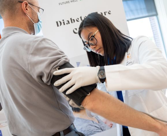 doctor of pharmacy student takes patient's blood pressure