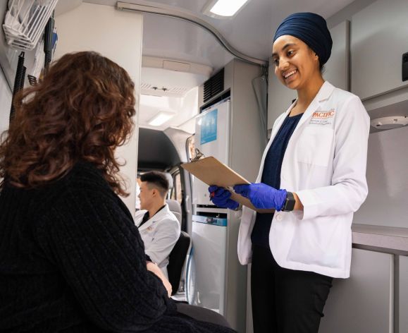 Doctor of pharmacy student with patient in mobile clinic van